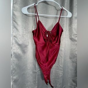 A small size Burgundy/red one piece top, area around boob is adjustable🔥